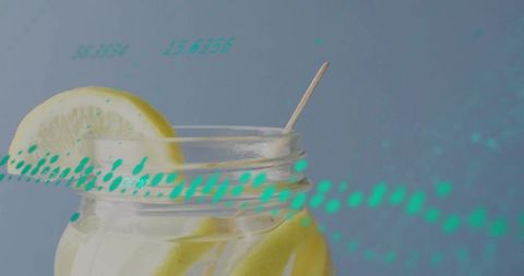 Mason jar lemon water with condensation and teal numeric overlay, minimalist citrus
