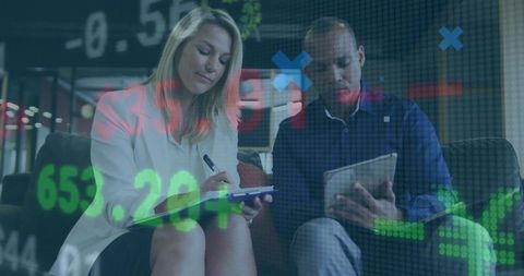 Business Professionals Analyze Stock Market Trends in Modern Office