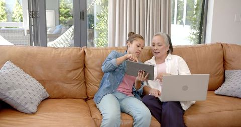Family bonding with technology: grandmother and granddaughter engaged