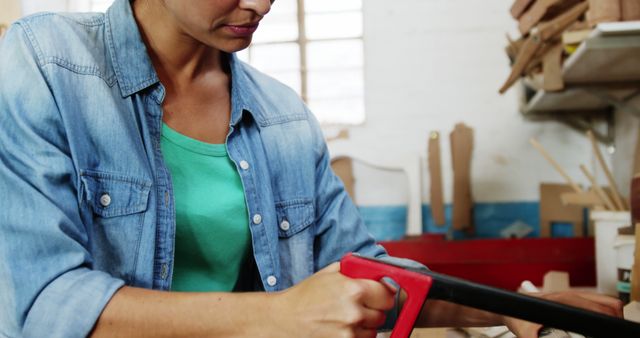 Woman Sawing Wood in Workshop - Download Free Stock Images Pikwizard.com