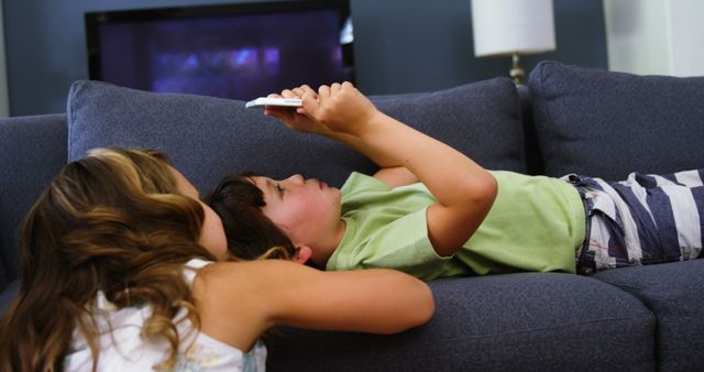 Children Relaxing on Couch Watching Smartphone in Living Room - Download Free Stock Images Pikwizard.com