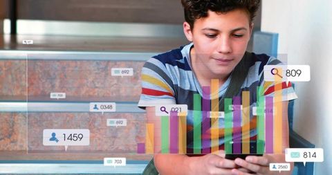 Teen boy checking smartphone with colorful analytics overlays on school stairs for edtech