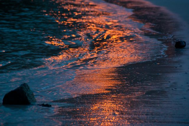 Sunset Reflections on a Tranquil Beach Shoreline - Download Free Stock Photos Pikwizard.com