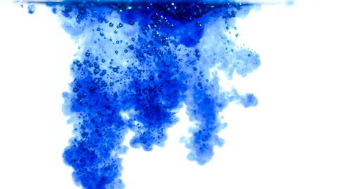 Vibrant Blue Ink Swirling Through Water Creating Dynamic Patterns