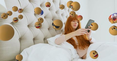 Woman Engaging with Social Media on Smartphone in Bed