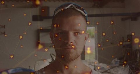 Man standing in garage workshop wearing sunglasses with glowing social media overlay