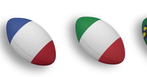 Rugby balls with national flags floating on white background