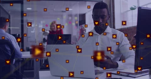 Digital Networking: Man on Smartphone with Multimedia Icons in Office