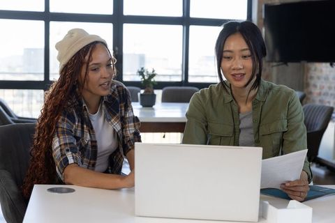Diverse coworkers collaborating at office meeting table
