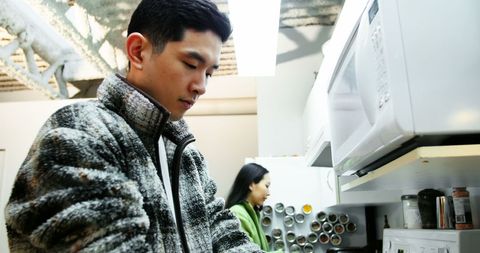 Man chopping vegetables in modern kitchen setting