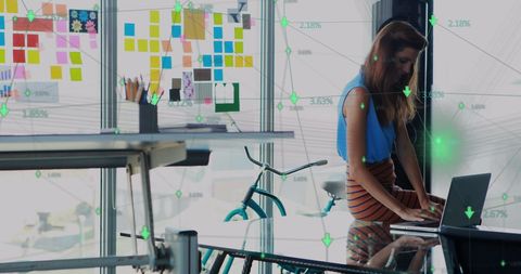 Businesswoman Analyzing Data in Modern Office with Technology Overlay