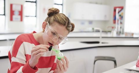 Girl conducting science experiment in school laboratory