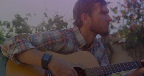 Acoustic Guitarist Playing Music Outdoors at Sunset