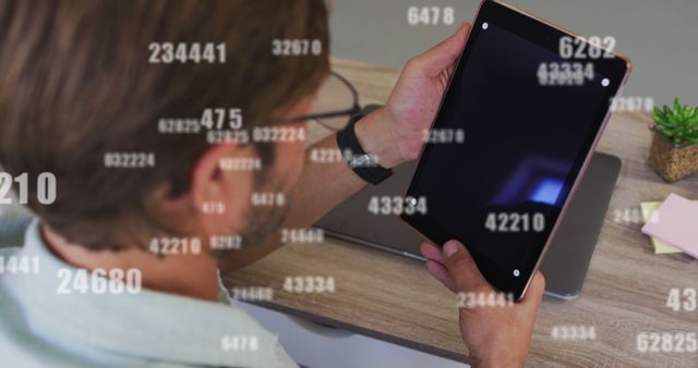 Man Utilizing Tablet for Technological Analysis with Numeric Overlay Display - Download Free Stock Images Pikwizard.com