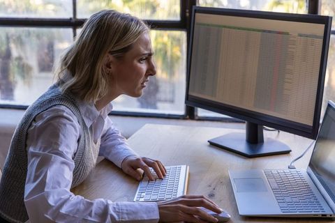 Female professional working on data analysis at modern desk