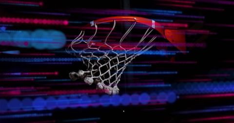 Basketball Hoop with Vibrant Neon Light Streaks in Dark Gym