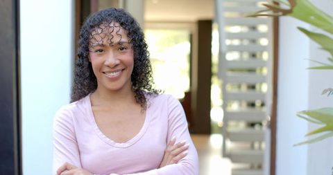 Smiling African American Woman in Modern Home Entranceway