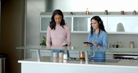 Close friends enjoy casual chat in modern kitchen