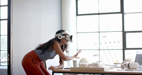 Designer using vr headset for futuristic ar interface interaction