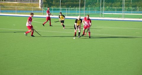 Competitive field hockey action on artificial turf