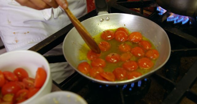 Chef Stirring Cherry Tomatoes in Pan on Stove - Download Free Stock Images Pikwizard.com