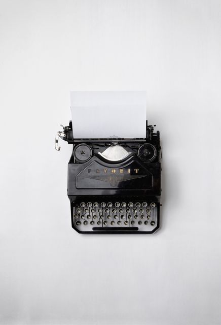 Vintage Black Typewriter with Blank Paper on Light Background - Download Free Stock Photos Pikwizard.com