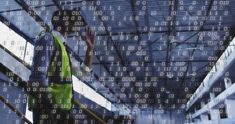 Construction worker talking on phone on station stairs with digital binary code overlay