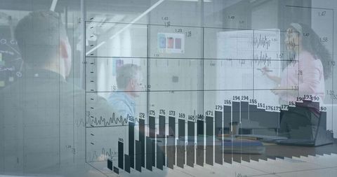 Woman presenting at whiteboard while team view laptop with 3D data charts overlay