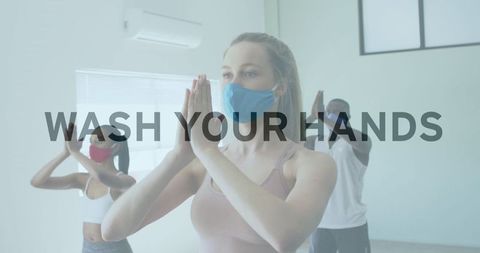 Diverse Group Practicing Yoga Wearing Masks with Safety Message