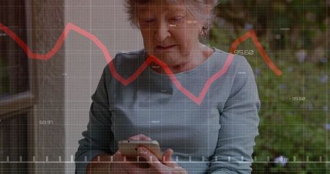 Senior Woman Analyzing Financial Data with Smartphone Outdoors