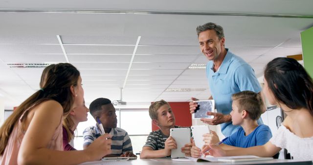 Teacher Engaging with Students in Classroom while Discussing Technology - Download Free Stock Images Pikwizard.com