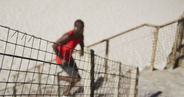 Blurred Silhouette of Runner Exercising on Beach Stairs - Download Free Stock Images Pikwizard.com