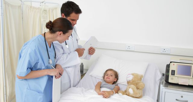 Doctors Checking on Recovering Child Patient in Hospital - Download Free Stock Images Pikwizard.com