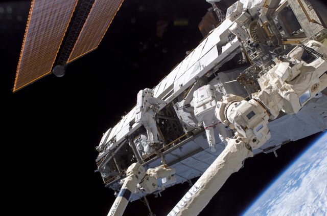 Astronauts are performing extravehicular activities on the Starboard One (S1) truss, newly installed on the International Space Station during the STS-112 mission. This detailed spacewalk captures the complexities of maintaining and expanding a space station in orbit. Ideal for educational materials on space missions, NASA works or for illustrating articles on space exploration and technology.