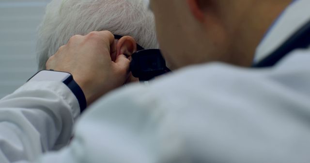 Doctor examining patient ear with otoscope in clinic - Download Free Stock Images Pikwizard.com