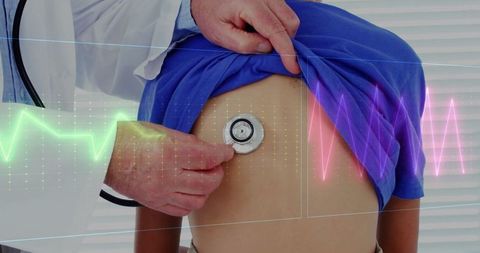 Doctor using stethoscope on patient with digital heart monitor overlay