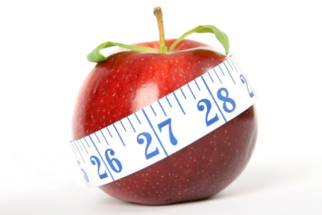 Red apple wrapped with a measuring tape around the middle represents symbolism for healthy eating, weight management, and wellbeing. Suitable for illustrating healthy diet articles, fitness guides, nutrition plans, health blogs, and promoting wellness programs.