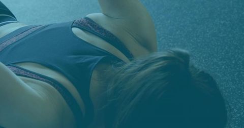 Woman engaging in floor exercise at gym for wellness & strength