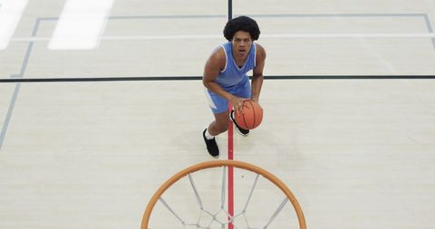 Focused Basketball Player Aiming Shot on Indoor Court