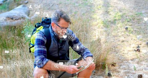 Hiker checking tablet on trail surrounded by floating social media notification icons