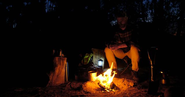 Man Camping in the Dark with Campfire - Download Free Stock Images Pikwizard.com