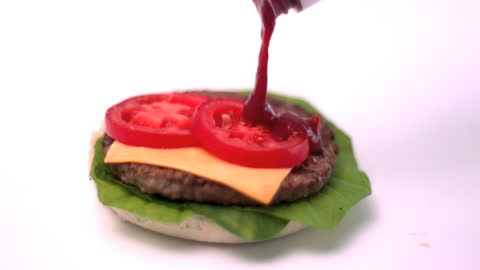Pouring Ketchup on Fresh Burger Ingredients in Slow Motion