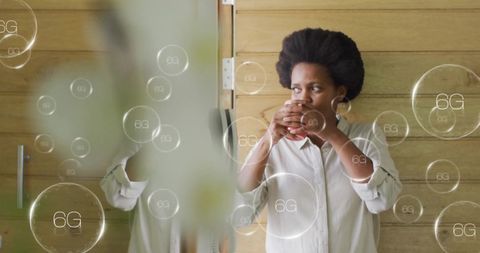 African woman drinking coffee with 6g digital interface overlay