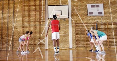 Teen Basketball Player Preparing Free Throw in School Gym