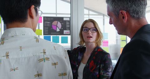 Businesswoman leading presentation on data analytics in modern office