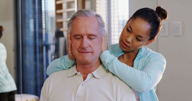 Physiotherapist Stretching Senior Man's Neck during Therapy Session - Download Free Stock Images Pikwizard.com