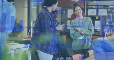 Young Professionals Collaborating Around Glass Data Visualization in Modern Coworking Office Space