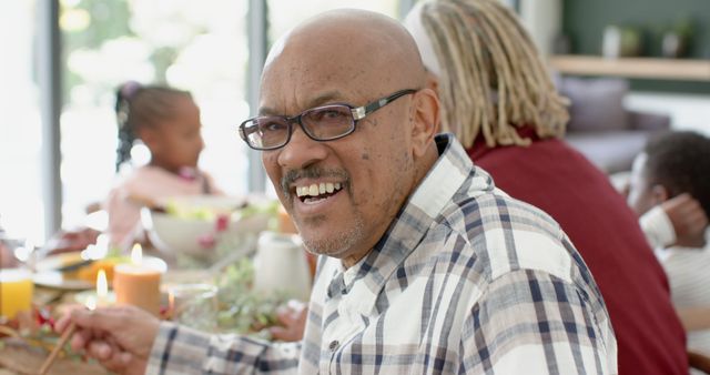 Smiling Senior Man Enjoying Family Gathering at Dining Table - Download Free Stock Images Pikwizard.com