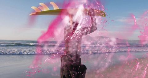 Surfer Carrying Board Through Vibrant Pink Powder on Beach