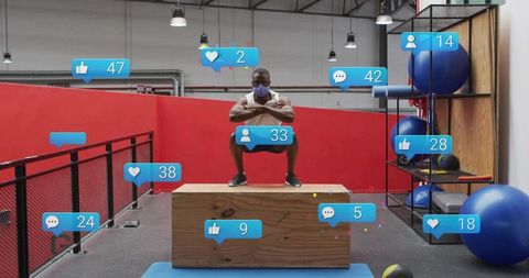 Masked athlete squatting on plyo box with social media engagement overlays